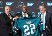  ?? JEFF CHIU / AP ?? Mike Grier, middle, poses for photos as he is introduced as the new general manager of the San Jose Sharks between assistant general manager Joe Will, left, and president Jonathan Becher at a news conference in San Jose on Tuesday.