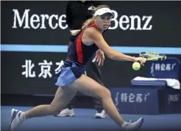  ?? — AP ?? Denmark’s Caroline Wozniacki returns to Petra Martic of Croatia in their second round women’s singles match in the China Open at the National Tennis Stadium in Beijing on Wednesday.