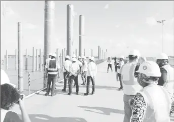  ?? ?? Members of the media and representa­tives from Polytechni­ca inspecting work on the 100 percent completed temporary structure of the Demerara Harbour Bridge