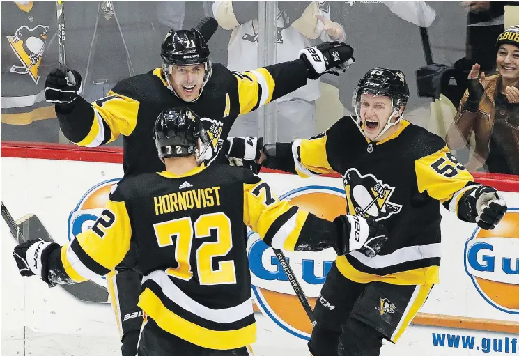  ?? — THE ASSOCIATED PRESS ?? Pittsburgh’s Jake Guentzel, right, celebrates his game-tying goal against Columbus Wednesday with teammates Evgeni Malkin and Patric Hornqvist.