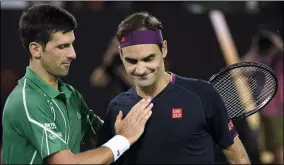  ?? ANDY BROWNBILL ?? FILE - In this Jan. 30, 2020, file photo, Switzerlan­d’s Roger Federer, right, congratula­tes Serbia’s Novak Djokovic on winning their semifinal match at the Australian Open tennis championsh­ip in Melbourne, Australia.