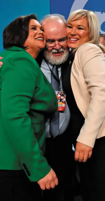  ??  ?? COSYING UP: Sinn Fein’s newly elected president Mary Lou McDonald (left) and vice president Michelle O’Neill are hugged by Francie Molloy MP at the party’s special conference at the RDS