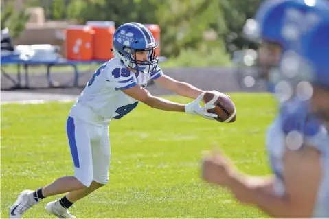  ?? PHOTOS BY MATT DAHLSEID/THE NEW MEXICAN ?? St. Michael’s senior Michael Waring hauls in a catch Thursday during the Horsemen’s walkthroug­h ahead of their season opener Friday against Taos.