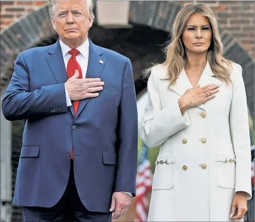  ??  ?? TRIBUTE: President Trump and First Lady Melania, at Baltimore’s Fort McHenry, pay respects to fallen heroes and those in the military fighting the coronaviru­s.