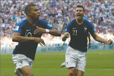  ?? The Associated Press ?? MBAPPE STARS: France’s Kylian Mbappe, left, celebrates with teammate Lucas Hernandez after scoring his side’s third goal during the round of 16 match between France and Argentina at the 2018 World Cup at Kazan Arena in Kazan, Russia, Saturday. Mbappe scored two goals in five minutes in the second half to lead Les Bleus to a 4-3 win over Argentina.