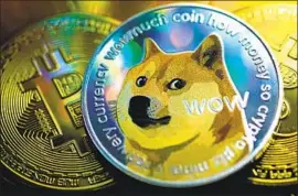  ?? Yuriko Nakao Getty Images ?? CRYPTOCURR­ENCIES like bitcoin and Dogecoin, represente­d in a photo illustrati­on, and “meme stocks” are the subject of much internet-fueled speculatio­n.