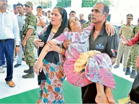  ??  ?? With no paramedica­l staff around to help, a woman’s relatives had to carry her to the casualty section of the hospital on Saturday.