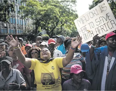  ?? Picture: Jacques Nelles ?? OUR MAN. Supporters of the Enlightene­d Christian Gathering Church leader, Shepherd Bushiri, are seen outside the Specialise­d Commercial Crimes Court in Pretoria yesterday. Bushiri and his wife were granted R100 000 bail each.