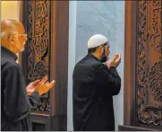  ??  ?? Imam Mujtaba Khaliq leads midday prayers at Masjidal-hayy, a new mosque in Sanford, Florida.