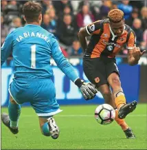  ??  ?? WILLING AND ABEL: Hernandez slots past Fabianski for 2-0