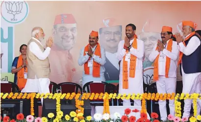  ?? ?? Prime Minister Narendra Modi is greeted by state Gujarat BJP leaders during a rally on Sunday. — ani