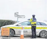  ?? PICTURE: PATRICK BROWNE ?? Scene: a garda near where human remains were found at Ballyandre­w, near Ferns, Co Wexford, yesterday.