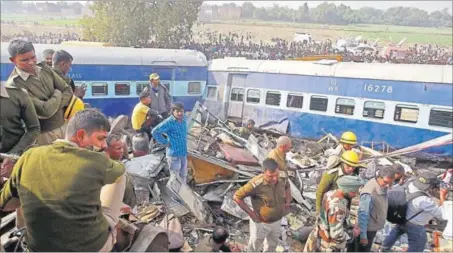  ?? REUTERS PHOTO ?? Rescue workers look for survivors at the site of the Indore-Patna Express’s derailment which claimed over 100 lives near Kanpur on Sunday.