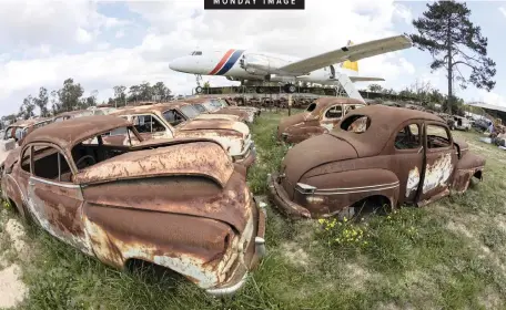  ?? | EPA ?? A CONVAIR 580 passenger aircraft in a classic car graveyard at the Wijnland Auto Museum in Cape Town. The museum, founded 30 years ago, houses the largest collection of classic and vintage cars in South Africa with more than 4 000 vehicles. The museum restores vehicles and often supplies them to the film industry.