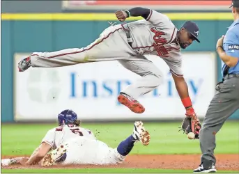  ?? David J. Phillip / The Associated Press ?? Atlanta second baseman Brandon Phillips (top) handles the throw from catcher Kurt Suzuki as Houston’s Jake Marisnick steals second base safely during the third inning of Wednesday’s game.