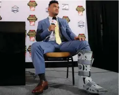  ?? [AP PHOTO] ?? Alabama quarterbac­k Tua Tagovailoa wears a protective boot on his injured foot as he speaks to reporters after winning the Maxwell Award and the Walter Camp honor on Dec. 6 in Atlanta.