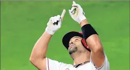  ?? JAYNE KAMIN-ONCEA/GETTY ?? Angels’ Albert Pujols points to the sky after hitting the 662nd home run of his career.