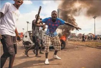  ?? Eduardo Soteras / AFP / Getty Images ?? Demonstrat­ors gather in the capital, Kinshasa. Police fired tear gas at scores of opposition supporters rallying to demand the nation’s long-serving President Joseph Kabila step down.