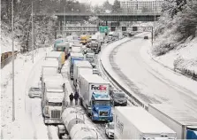  ?? Dave Killen/The Oregonian via Associated Press ?? Cars and trucks sit backed up Thursday on Interstate 84 in Portland, Ore. Nearly a foot of snow fell there Wednesday.