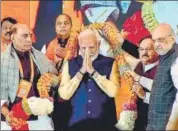  ?? PTI ?? PM Narendra Modi is garlanded by Union ministers Amit Shah, Rajnath Singh and BJP chief JP Nadda in Delhi on Sunday.