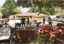  ?? Edmund D. Fountain / New York Times ?? Volunteers work to gut damaged homes in Baton Rouge, La., last week. A storm that began Aug. 12 dumped as much as 2 feet of rain over 48 hours in some areas.