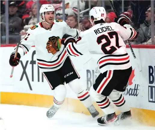  ?? PAUL SANCYA/AP ?? Despite a recent 15-game drought, Taylor Raddysh (left, with Lukas Reichel) leads current Blackhawks players with 16 goals this season.