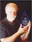  ?? SUBMITTED PHOTO ?? Lawrence McElroy, director of arts and culture for Historic Cane Hill Museum, displays an award recently received by the museum, a 2020 AMA Award for Outstandin­g Achievemen­t in Exhibition Design for an exhibit on 19th century potters of Northwest Arkansas.