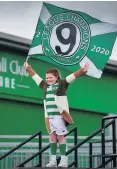  ??  ?? Title nine: a lone Celtic supporter celebrates