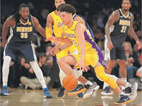  ?? | SEAN M. HAFFEY/ GETTY IMAGES ?? Lakers rookie Lonzo Ball has missed two consecutiv­e preseason games after spraining his ankle last Monday against the Nuggets.