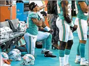  ?? CHARLES TRAINOR JR./MIAMI HERALD ?? Miami Dolphins Kenny Stills and Albert Wilson kneel during the anthem before a Thursday preseason game.