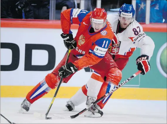  ??  ?? Russia’s Evgeni Malkin (left) and Czech Republic’s Jakub Nakladal in action during the IIHF Hockey World Championsh­ips on Sunday.