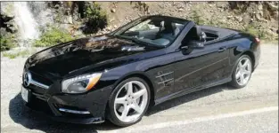  ?? PHOTOS: ALEXANDRA STRAUB, SPECIAL TO THE GAZETTE ?? The 2013 Mercedes-Benz SL 550’s long hood, air inlets with chrome-plated fins, standard AMG styling package and chrome-plated twin trapezoida­l exhaust pipes help give this luxury roadster a sporty, sleek look.