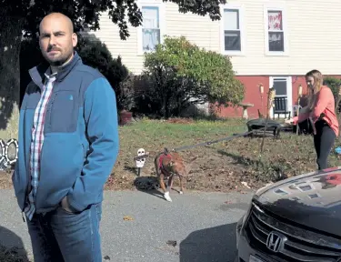  ?? Michael Dwyer, The Associated Press ?? Real estate investor Shad Elia poses outside one of his properties as tenant Krystal Dingler walks her dog Thursday in Haverhill, Mass. Now that government stimulus benefits have expired, tenants are falling behind on their payments, and Elia wonders how much longer his lenders will cut him slack.