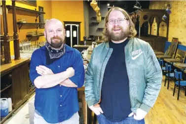  ?? STAFF PHOTO BY C.B. SCHMELTER ?? Marty Bohannon, left, and George MacEwan pose at the Cherry Street Tavern on Thursday in downtown Chattanoog­a. Cherry Street Tavern is set to open in the former space of The Mad Priest Coffee & Cocktails this year.