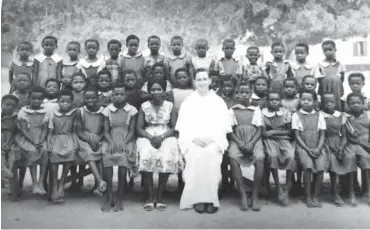  ??  ?? Fr. Raymond Hickey, with some of his students during the early days in the North East