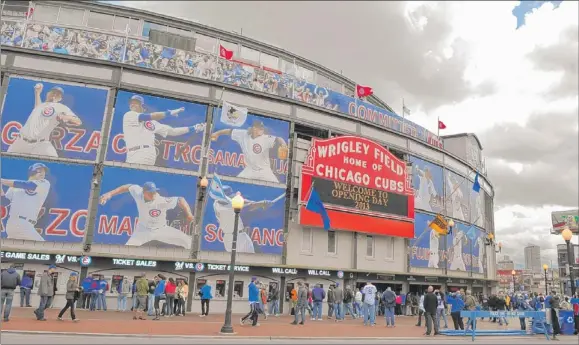  ?? | TOM CRUZE~SUN-TIMES ?? Wrigley Field is decked out for the Cubs home opener against the Milwaukee Brewers on Monday.