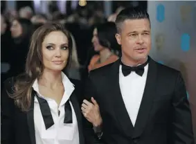  ?? ANDREW COWIE/ AFP/GETTY IMAGES ?? Parodying their likeness for all to see, Angelina Jolie, left, and Brad Pitt appear in almost identical attire for the recent BAFTA ceremony.