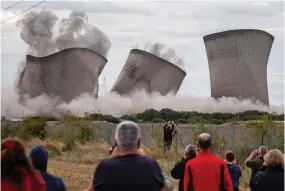  ??  ?? Spectacula­r: Didcot’s cooling towers tumble down yesterday