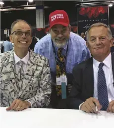  ??  ?? Bureau of Engraving and Printing Director Len Olijar (wearing a suit with fanciful depictions of $100 notes!), Mike Fuljenz and United States Mint Director David J. Ryder at the 2019 World’s Fair of Money.