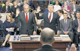  ?? ALEX BRANDON/AP ?? Department of Justice Inspector General Michael Horowitz, left, and FBI Director Christophe­r Wray get sworn in Monday for a hearing of the Senate Judiciary Committee.