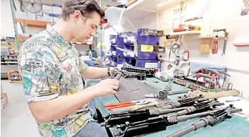  ??  ?? A worker assembles an AR-15 rifle at Delta Team Tactical in Orem, Utah.