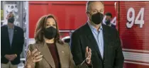 ?? RINGO H.W. CHIU — THE ASSOCIATED PRESS ?? Vice President Kamala Harris, left, wearing a face mask and accompanie­d by second gentleman Douglas Emhoff, speaks with firefighte­rs while visiting the Los Angeles Fire Department Station 94.