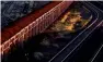  ?? Reuters ?? A train loaded with rio tinto iron ore, whose output overcame low prices. —