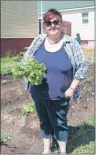  ?? SUBMITTED PHOTO/KIMMY MCPHERSON ?? Michelle MacIntyre, a volunteer at the Glace Bay Food Bank, holds lettuce freshly picked from the garden, which was used to garnish 70 hamburgers during a recent meal served at the food bank.