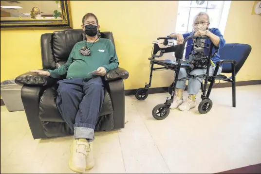  ?? Erik Verduzco Las Vegas Review-Journal @Erik_Verduzco ?? Cheryl Ray, 72, right, waits with her son Michael, 47, after he received the second dose of the COVID-19 vaccine on March 17 at the Nevada Adult Day Healthcare Center in Las Vegas during an on-site clinic run by Albertsons pharmacy personnel.