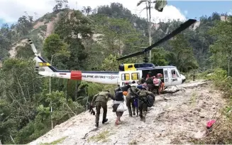  ?? (Dani Doguiles/ PIA 12) ?? ISOLATED – Villagers in Sitio Kapatagan, Barangay Luayon, Makilala, North Cotabato, which was isolated after earthquake damage closed down the road leading to it, are rescued by an Air Force helicopter.