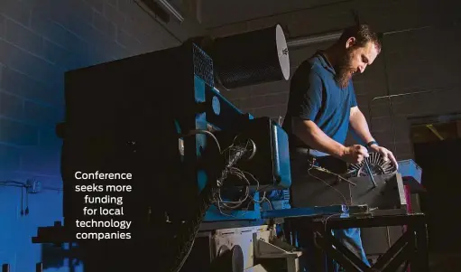  ?? Marie D. De Jesus photos / Houston Chronicle ?? Orbital Traction test engineer Joe Bivona installs a fan drive, above and below. The company makes a device that makes diesel engines more efficient. Conference seeks more funding for local technology companies