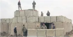  ?? REUTERS ?? Afghan National Army soldiers stand at a checkpost where clashes took place between Taliban and Afghan forces in Kunduz.