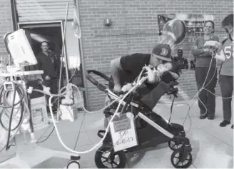  ?? Helen H. Richardson, The Denver Post ?? Casey Christense­n on Wednesday kisses his giggling 1-year-old son, Ryker, who squints in the daylight in a courtyard at Children’s Hospital in Aurora.