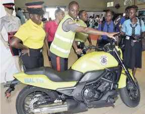  ?? IAN ALLEN/PHOTOGRAPH­ER ?? Sergeant Daniel Bennett from the Motorised Division of the Jamaica Constabula­ry Force gives tips on how to manoeuvre a motorcycle. The occasion was the Police Week/Policing Career Expo and Youth Forum at The Mico University College in Kingston on November 28.